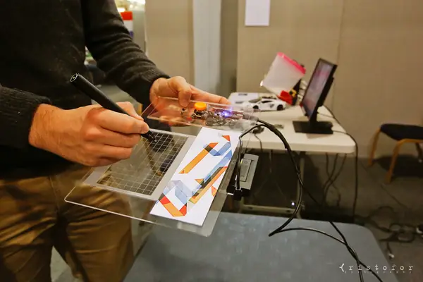 Inventor demonstrating a transparent touch-panel prototype at the British Invention Show 2014