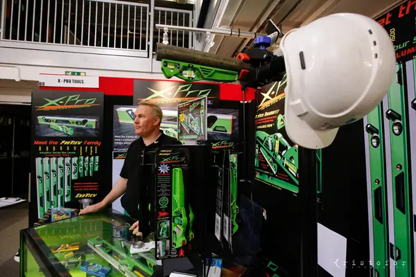 Exhibitor among green and black X-Pro tool displays at the British Invention Show 2014