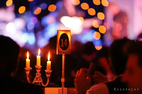 Candelabra and table number 14 glowing in the ballroom at the 2014 bis Awards at The Savoy