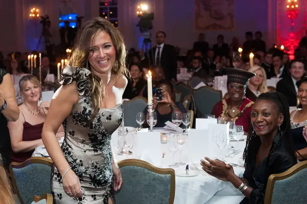 Guests applauding at candlelit dinner tables at the 2014 bis Awards at The Savoy