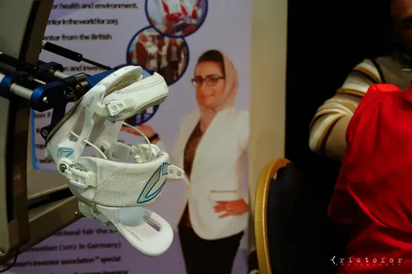 White prototype device in front of an exhibitor poster at the British Invention Show 2014