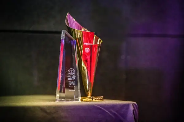 Gold and glass bis trophies on a draped table