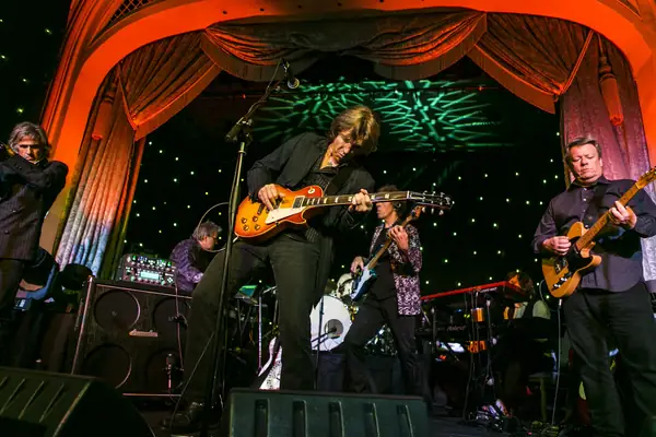 Rock band on stage beneath red curtains at a bis awards evening