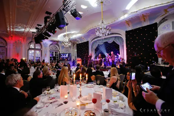 Band on stage seen across the candlelit dinner tables at the 2014 bis Awards at The Savoy