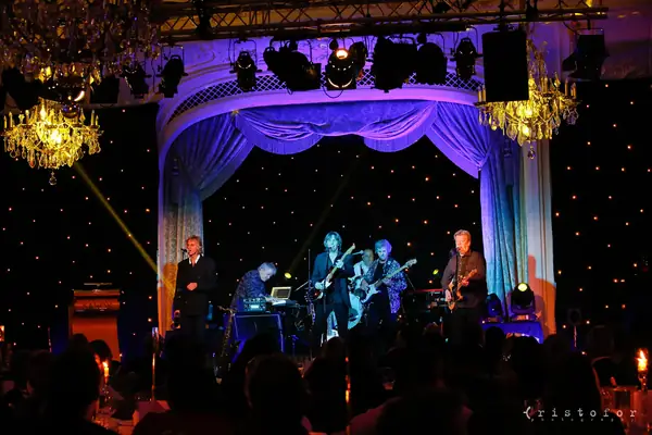 Band on stage beneath chandeliers at the 2014 bis Awards at The Savoy