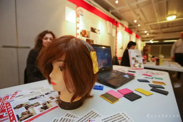 Mannequin head and hair accessories on an exhibitor table at the British Invention Show 2014