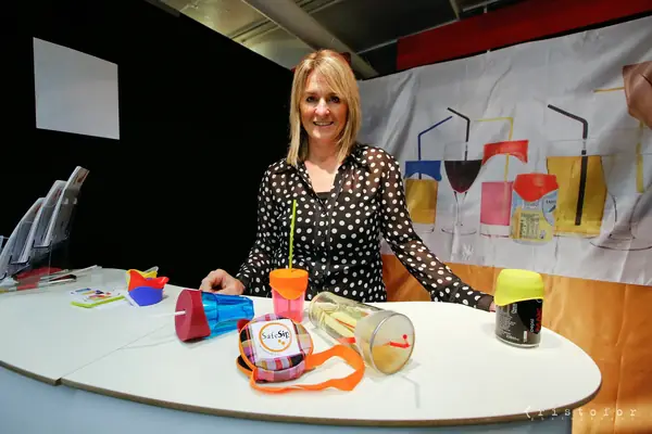 Exhibitor with colourful cups and lids on her stand at the British Invention Show 2014