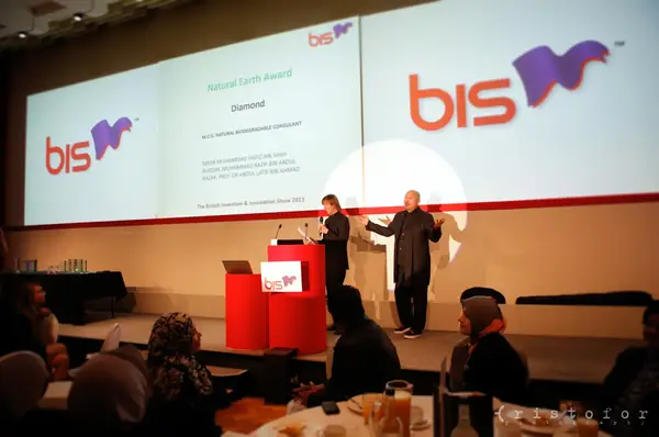 Award presentation on stage beneath the bis screens at the British Invention Awards 2013