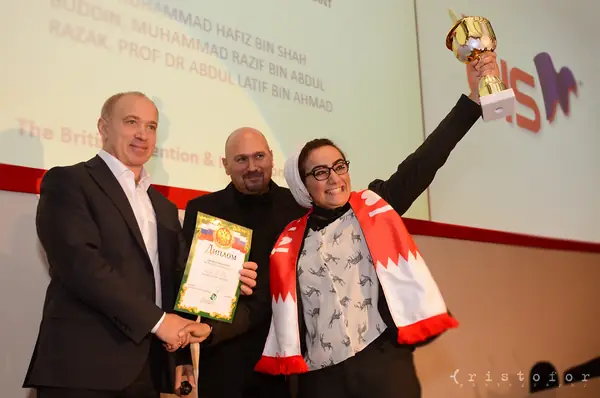 Winner raising a gold cup on stage at the British Invention Awards 2013