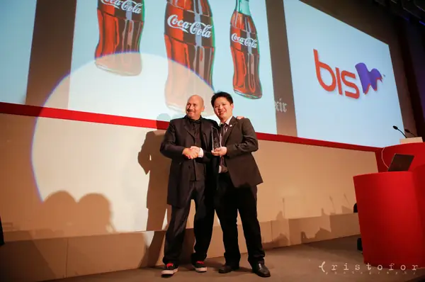 Two men on stage in front of a screen at the British Invention Awards 2013